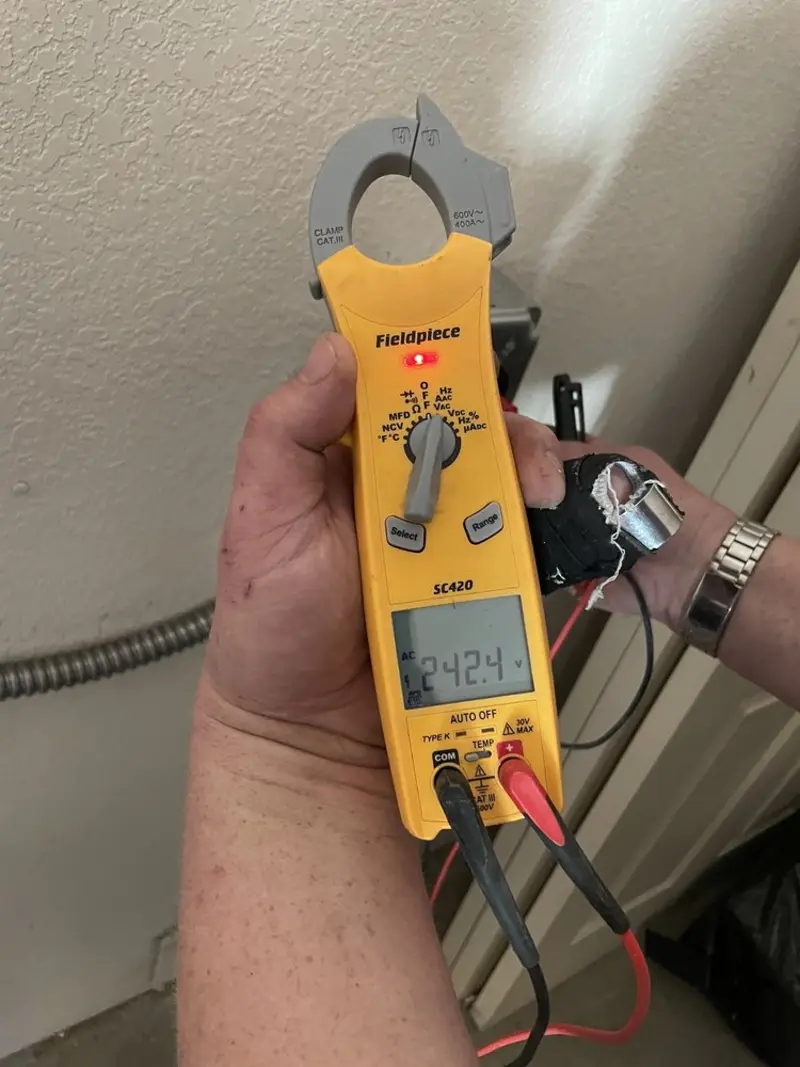 Voltage testing with clamp meter during Ceiling Fan Installation in Depew